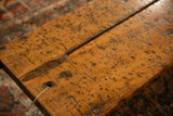 Distressed reclaimed wooden tabletop with visible planks and aged metal fasteners.