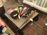 Overhead view of upcycled black factory cart coffee table, showing light wood top.