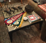 Upcycled antique factory cart coffee table with light wood top and dark metal frame.