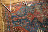 Antique Kurdish Hamadan rug's navy and red geometric field with visible, mostly even pile wear.
