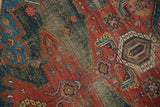 Oversized asymmetric medallion, mostly even wear on antique Hamadan rug in cherry and navy.
