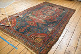 Antique Hamadan rug corner, with secured fringe and colorful floral border design.