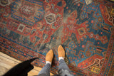 Antique Hamadan rug, overhead with feet, oversized asymmetric medallion, cherry red, navy, visible wear.