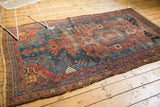 Antique Kurdish Hamadan rug, oversized asymmetric medallion, red, navy geometric motifs, mostly even wear.