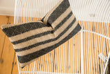 Onyx black and natural geometric basketweave pattern on the remnant pillow.