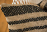 Reclaimed Remnant Pillow in natural beige with woven onyx black geometric striped patterns.
