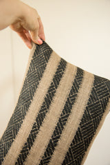 Detail of the Onyx Black and Natural Pillow's woven striped texture.