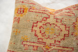 Hand-knotted antique Turkish rug fragment pillow, showing textured red and mustard yellow geometric motifs.
