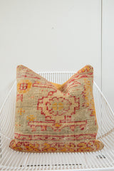 Antique Turkish rug fragment pillow, geometric red and beige pattern, with mustard backing.