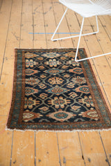 Dark blue field, intricate floral Veramin design, and tattered fringe of the vintage Lilihan rug.