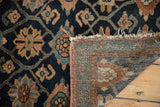 Vintage Lilihan rug's Veramin pattern in midnight blue, revealing woven back and tattered fringe.
