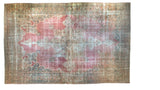 Antique distressed Kermanshah carpet with an ornate ivory and blue medallion on a faded raspberry pink field.