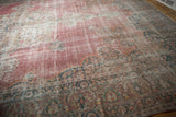Mostly even wear across the knot heads of the faded raspberry pink and ivory Persian carpet.
