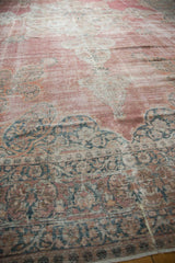 Low pile texture and mostly even wear on the faded raspberry pink antique carpet.