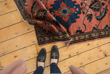 Vintage Persian Lilihan rug corner showing geometric border, scrolling leaves, and minor tatter.