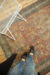 A person's view showing the beautifully worn texture of an antique Northwest Persian runner.