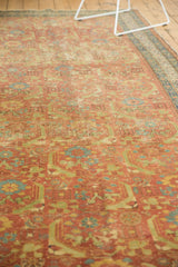 Low angle view showing the textured, worn pile of an antique Persian rug's Herati pattern.