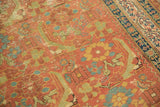 Foundation shows through the worn knot heads of the antique runner's rust-colored Herati motif.