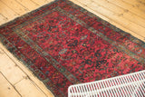 Vintage Lilihan rug end showing tattered selvage, wear, and white knots.