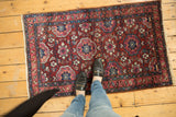 A vintage Lilihan Persian rug with gem-toned floral medallions styled on a wood floor for scale.