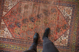 Antique Qashqai rug, terra cotta shadow boteh, rare saffron border, showing wear.