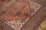 Antique Qashqai rug corner: shadow boteh field, ivory, and unusual saffron gold borders.