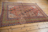 Rare saffron gold border, rich terra cotta field, navy blue floral motifs, with softened pile.