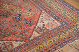 Antique Qashqai rug corner showcasing rare saffron gold border and terra cotta shadow boteh.