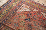 Antique Persian Qashqai rug corner showing shadow boteh field and rare saffron gold border.