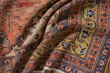 Detail of the antique Qashqai rug, showcasing its rare saffron gold border and terra cotta floral motifs.