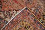 Antique Qashqai rug's folded corner, showing worn pile to foundation, tattered fringe, and saffron gold border.