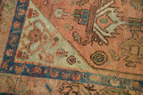 Distressed Malayer rug corner; pale terra cotta, seafoam green patterns, and sapphire blue border.