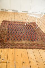 Antique Kurdish rug, allover navy blue and brick red paisley botehs, geometric border, mostly even wear.