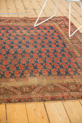 Antique Kurdish rug's geometric serrated leaf border with light tatter visible.