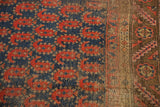 Antique Kurdish rug: navy field, red paisley botehs, chocolate geometric border.