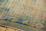 Distressed Oushak carpet showing mostly even wear to knot heads, foundation showing, faded blues.