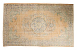 Distressed Oushak carpet with soft peach field, pale blue medallion, and mint floral vinery, 5'9