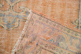 Distressed Oushak rug pile showing areas of foundation and the reverse weave.