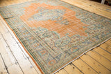 Distressed Oushak border and field with low pile, Rococo vinery in tangerine and blue.