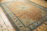 Low shorn pile of vintage Oushak rug, dusty apricot field, floral vinery, serrated leaf border.