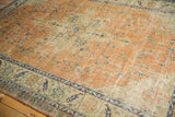 Worn texture of a vintage Oushak rug with terracotta, ivory, and navy floral vinery.