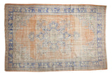 Distressed Oushak rug with apricot field, bold sky blue medallion and ornate spandrels.