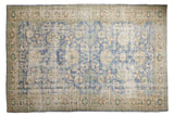 Vintage distressed Oushak carpet with faded blue, ivory, and mint floral design.