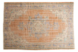 Vintage Distressed Oushak carpet with faded apricot, ivory, and blue geometric medallion, 6' x 8'10