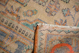 Distressed Oushak rug showing low pile, visible foundation, hand-knotting, and fringe.