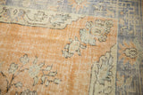 Distressed apricot field with intricate scalloped motifs and light blue border.