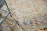 Vintage Distressed Oushak Carpet's textural surface, revealing faded blue, pale red, and ivory floral motifs.