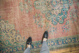 Distressed blush rose Oushak carpet with faded floral motifs and soft abrashed texture.