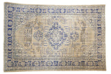 Vintage Distressed Oushak rug with navy blue scalloped medallion, seasons design on antique ivory field.