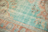 Distressed aqua field with terracotta Rococo pattern and visible wear on vintage Oushak rug.